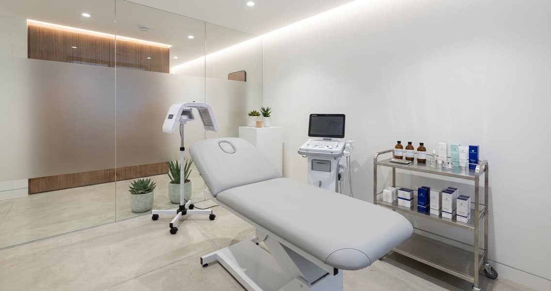 Modern UK aesthetics clinic interior with clean treatment room and advanced equipment
